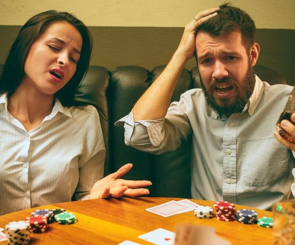 side-view-photo-male-female-friends-sitting-wooden-table-men-women-playing-card-game-hands-with-alcohol-close-up_155003-22099